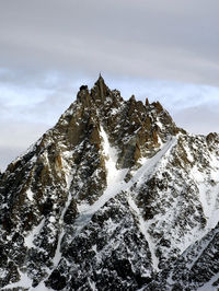 Low angle view of snowcapped mountain against sky