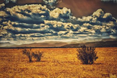 Scenic view of mountains against cloudy sky