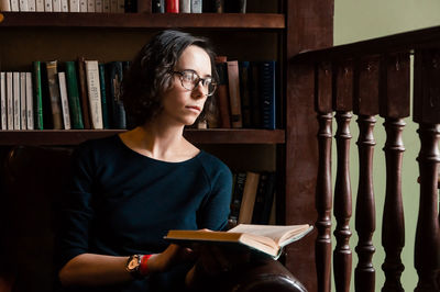 A girl in a library with a book