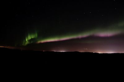 Scenic view of silhouette mountain against sky at night