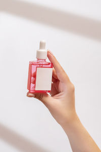 Close-up of hand with soap on white background