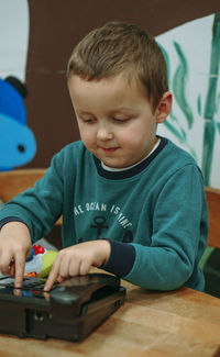 Portrait of boy playing with toy blocks