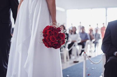 Midsection of bride and groom during wedding