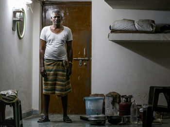 Full length of mature man standing at home