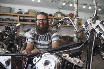 A young man repairing a motorcycle