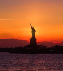 Statue of liberty against sky during sunset