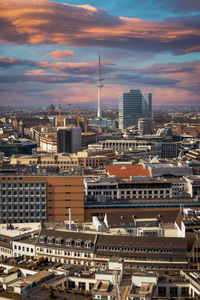 High angle view of modern buildings in city against sky during sunset