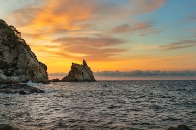 View of sea against cloudy sky during sunset