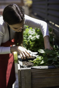 Young woman gardening at yard