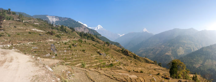 Scenic view of mountains against blue sky