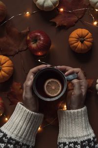 Midsection of person holding coffee cup