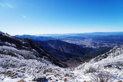 Scenic view of mountains against clear blue sky