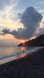 Scenic view of beach against sky during sunset