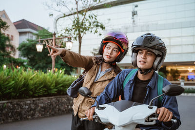 Side view of young woman riding bicycle