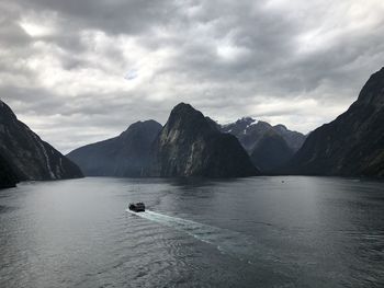 Scenic view of lake and mountains against sky