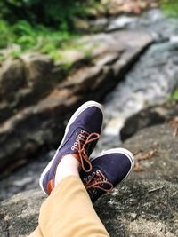 Low section of man wearing shoes
