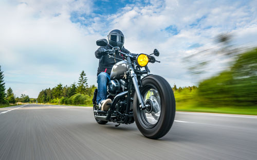 Motorcycle parked on road against sky