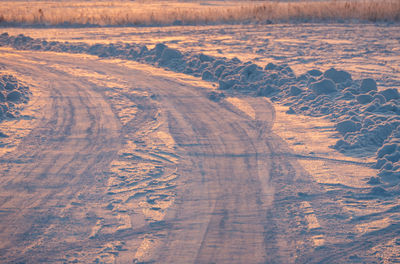 Winter landscape, tire tracks on the snow, snow road