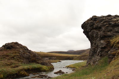 Scenic view of rocks and mountains against sky