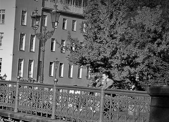 Low angle view of tree against building in city