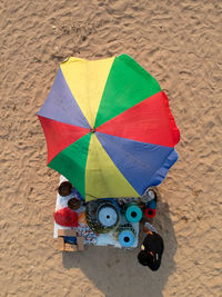 High angle view of man standing by objects for sale at beach