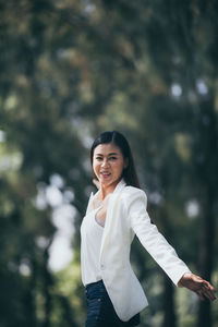 Portrait of a smiling young woman standing outdoors