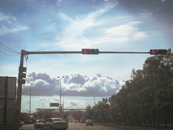 Cars on road against sky