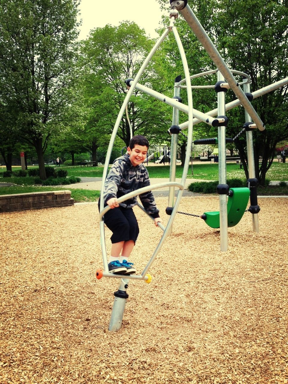 full length, casual clothing, lifestyles, childhood, leisure activity, person, tree, elementary age, park - man made space, swing, playground, boys, sunlight, girls, day, enjoyment, sitting, young adult