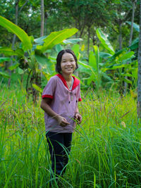Portrait of smiling woman standing on land