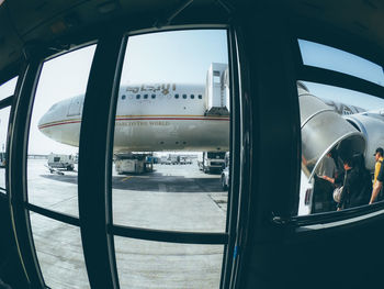 Fish-eye lens of airplane seen from bus door