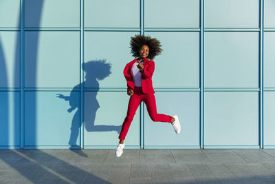 Woman jumping cheerfully on sunny day