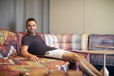 A man relaxes on a comfortable modern couch.