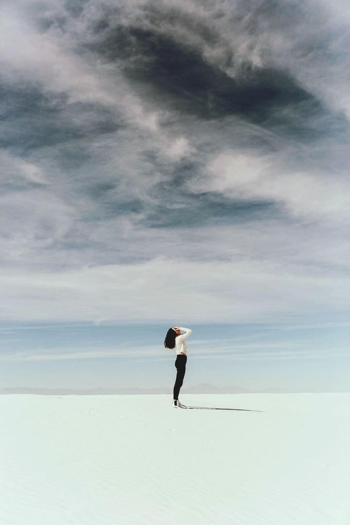 cloud - sky, sky, one person, full length, land, lifestyles, real people, leisure activity, beauty in nature, nature, scenics - nature, tranquility, tranquil scene, beach, day, standing, adult, sea, outdoors