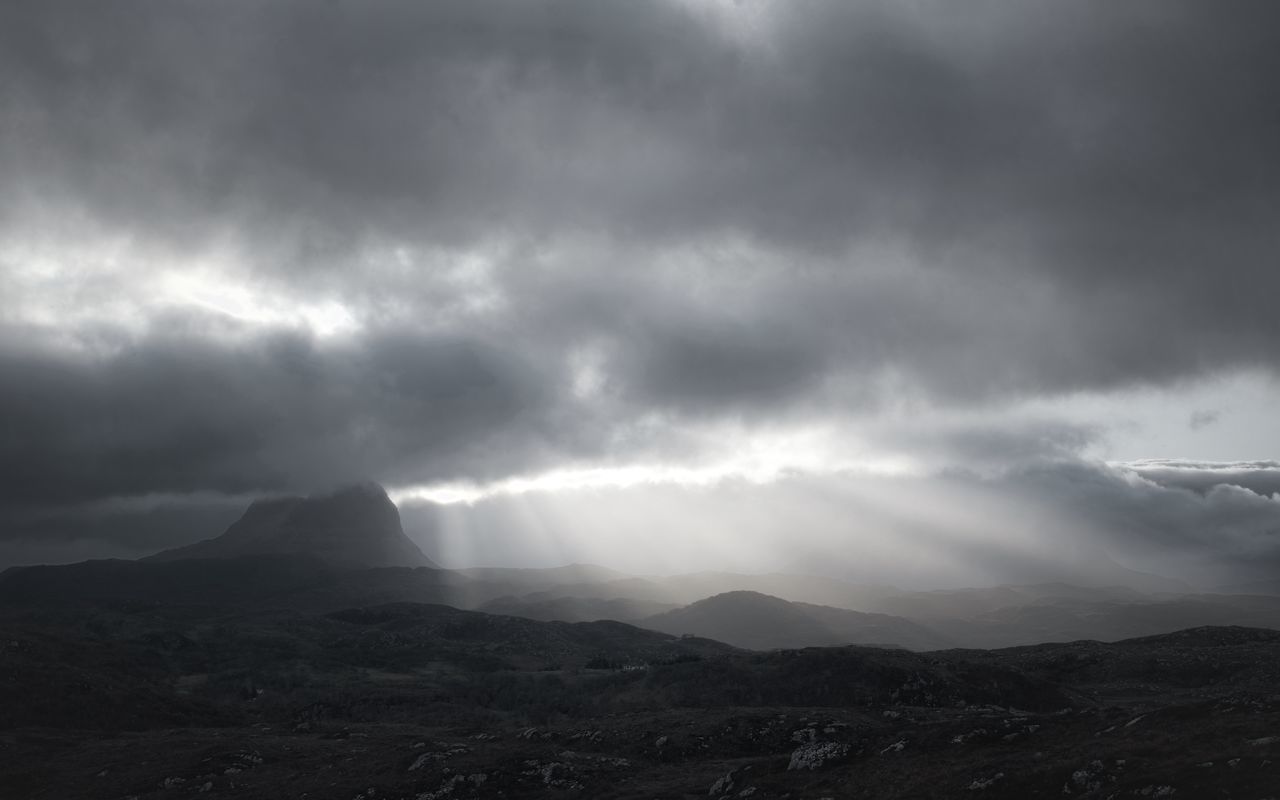 cloud, environment, sky, mountain, beauty in nature, storm, landscape, scenics - nature, horizon, dramatic sky, nature, storm cloud, thunderstorm, darkness, overcast, black and white, no people, mountain range, cloudscape, outdoors, dark, fog, sunbeam, rain, ominous, monochrome, awe, travel destinations, land, atmospheric mood, travel, dramatic landscape, non-urban scene