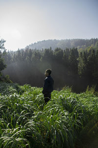 Man standing on field against sky