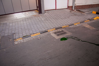 High angle view of text on wet footpath