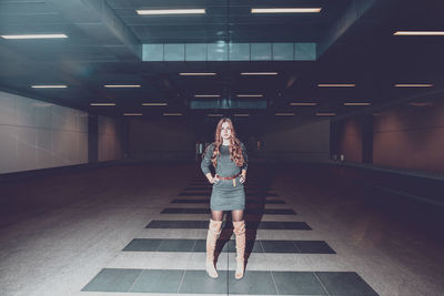 Full length of woman standing in subway