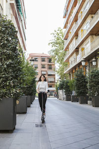 Young woman with e-scooter in the city