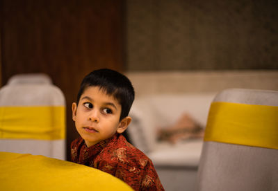 Portrait of young woman sitting at home