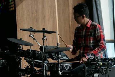 Young man sitting on stage