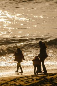 Silhouette people on beach