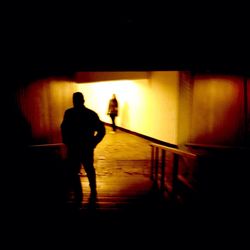 Silhouette of woman in dark room