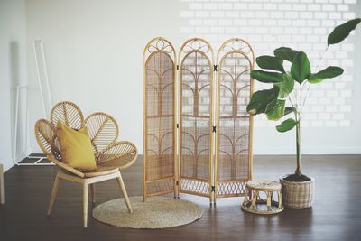 Potted plants on table against wall at home