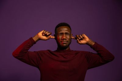 Portrait of young man against gray background