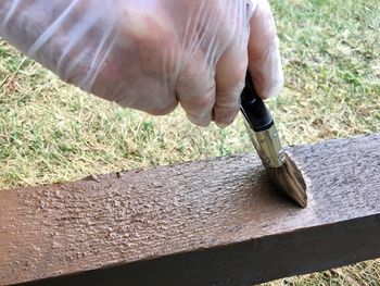 Midsection of person working on wood