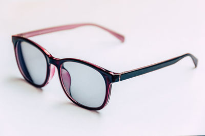 Close-up of sunglasses against white background