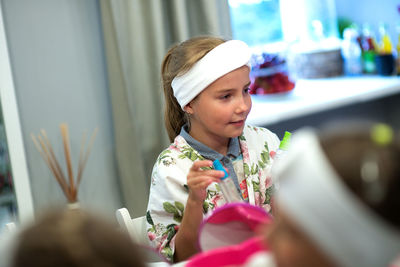 Girl looking away while sitting at spa