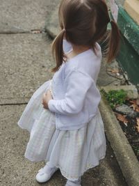 High angle view of girl standing on footpath