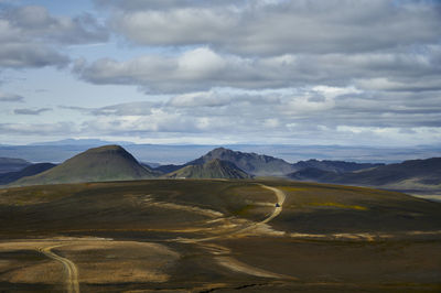 Curvy road through valley on cloudy day