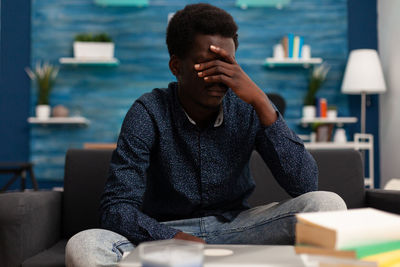 Young man sitting on table